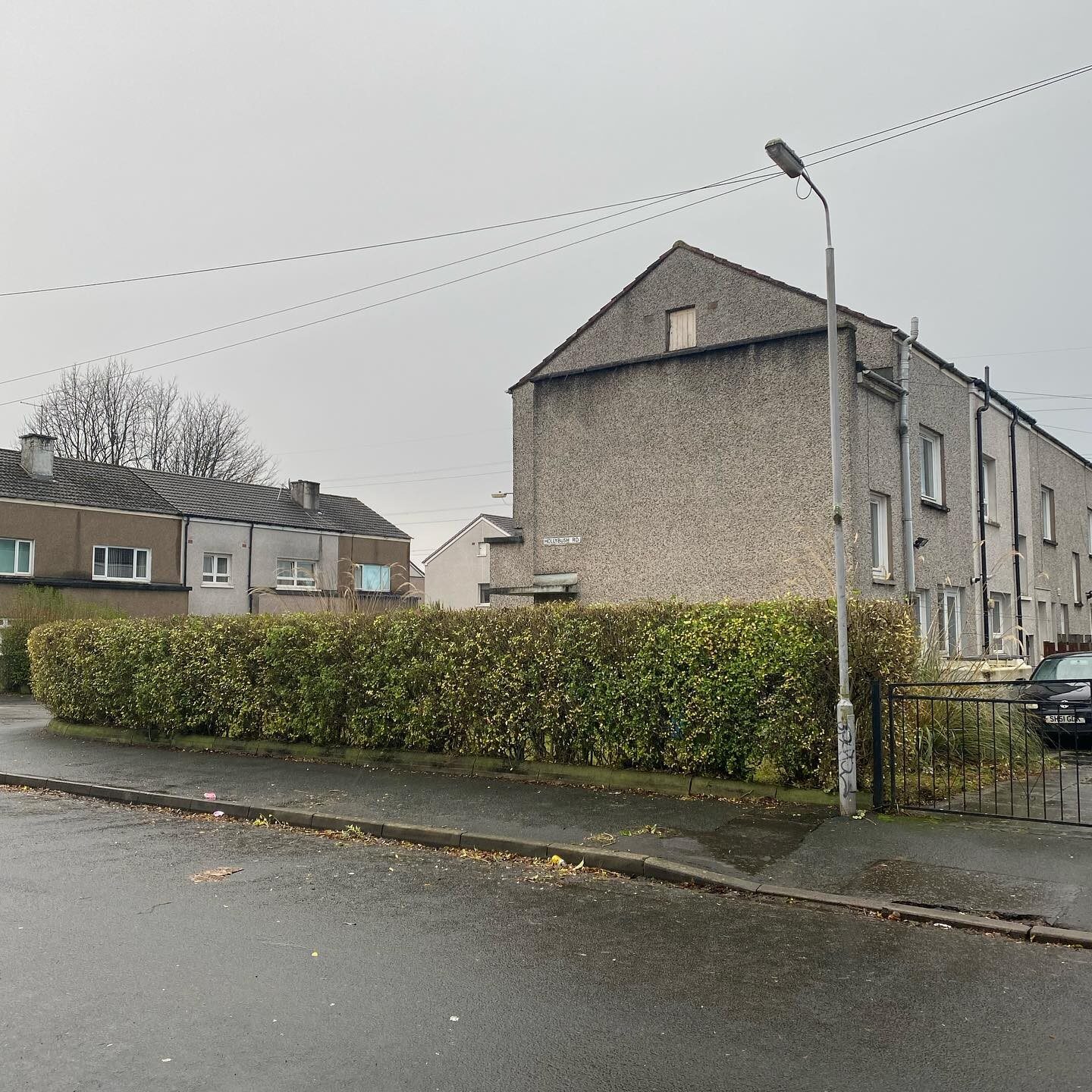 The same lamp post, gate and gable with the hedge cut back down to six foot and squared off