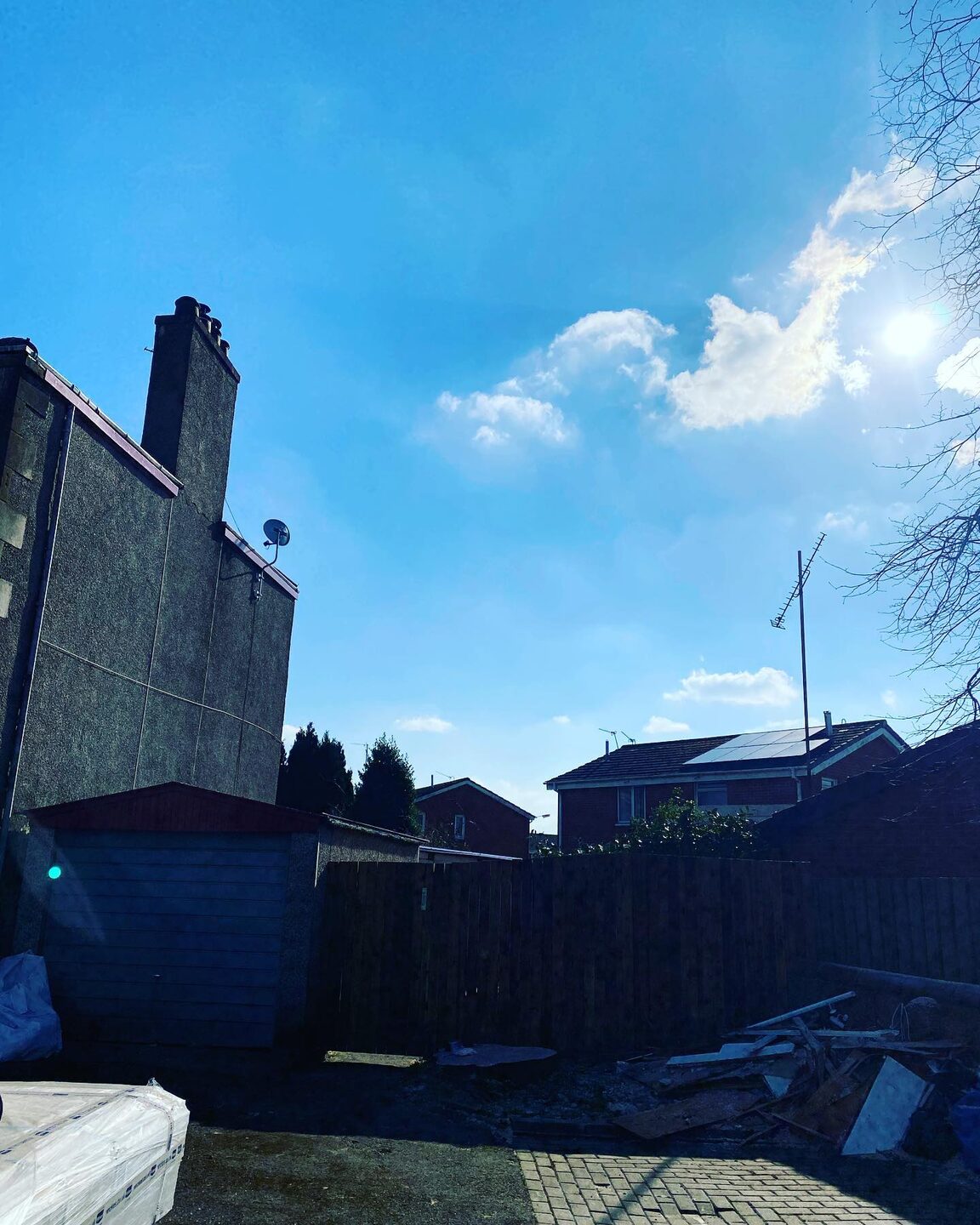 The same spot with the beech gone, open sky above the gable and the ground cleared